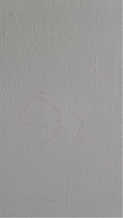 Red marker stain still visible after one coat of paint