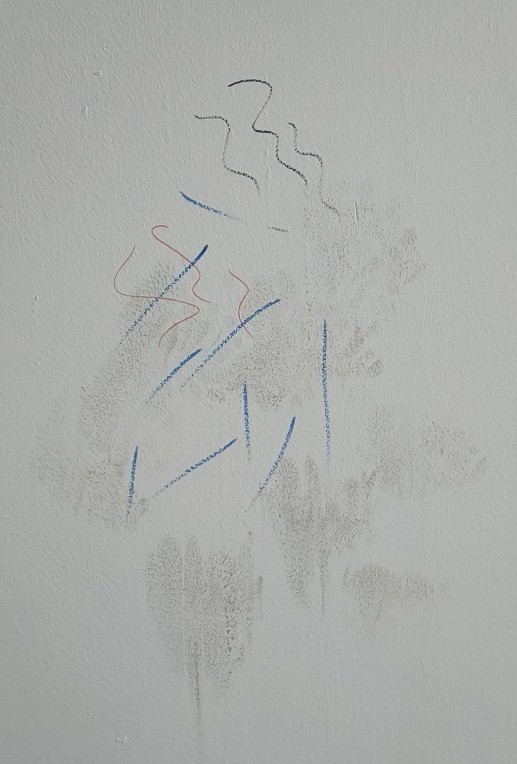 Wall stains and marker marks before repainting