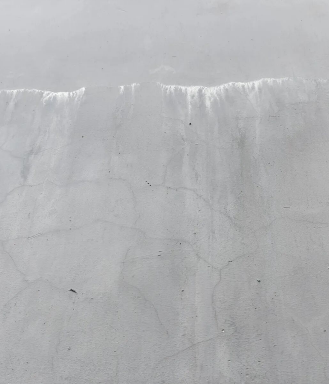 white exterior wall with dampness and efflorescence